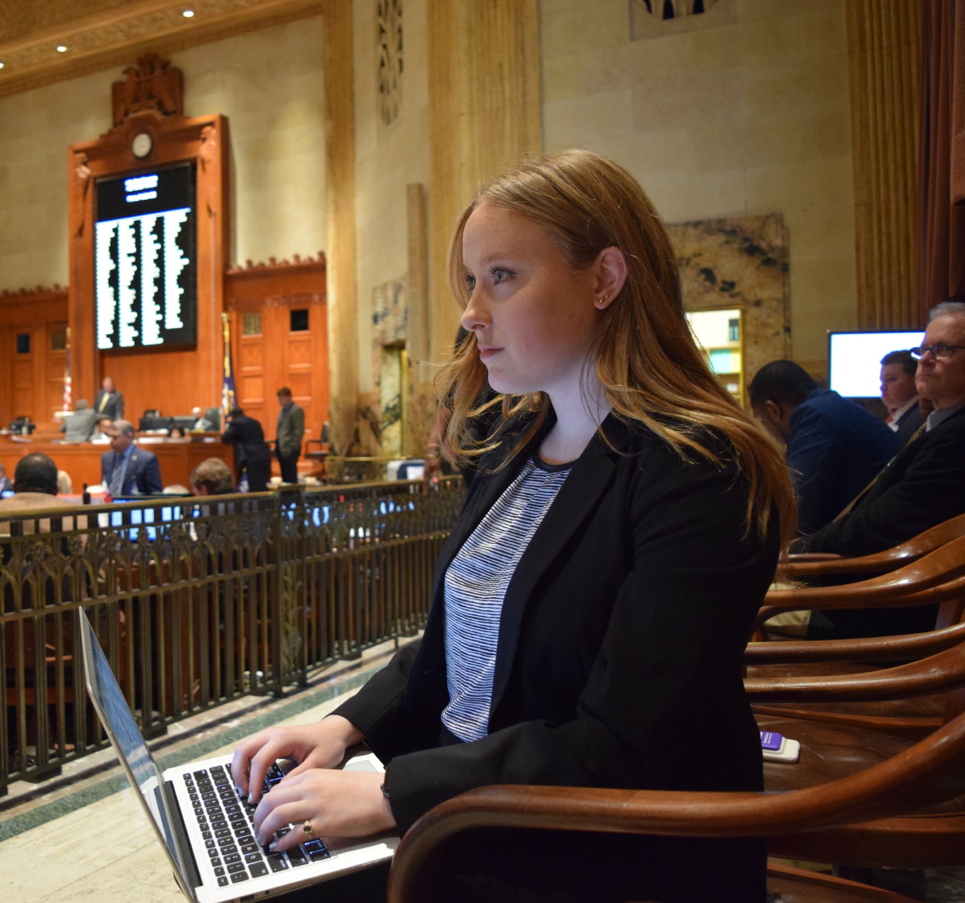 Political Communication student taking notes on a laptop